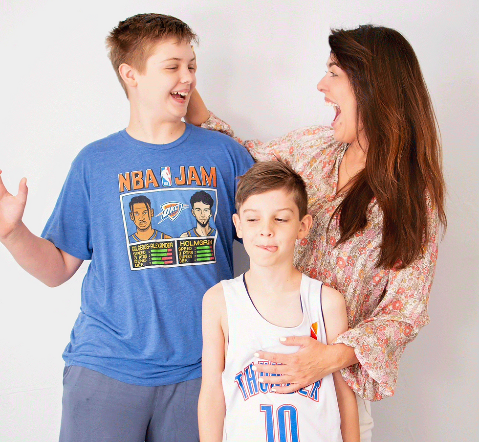 Image of a mom laughing with two boys during a studio photo session.