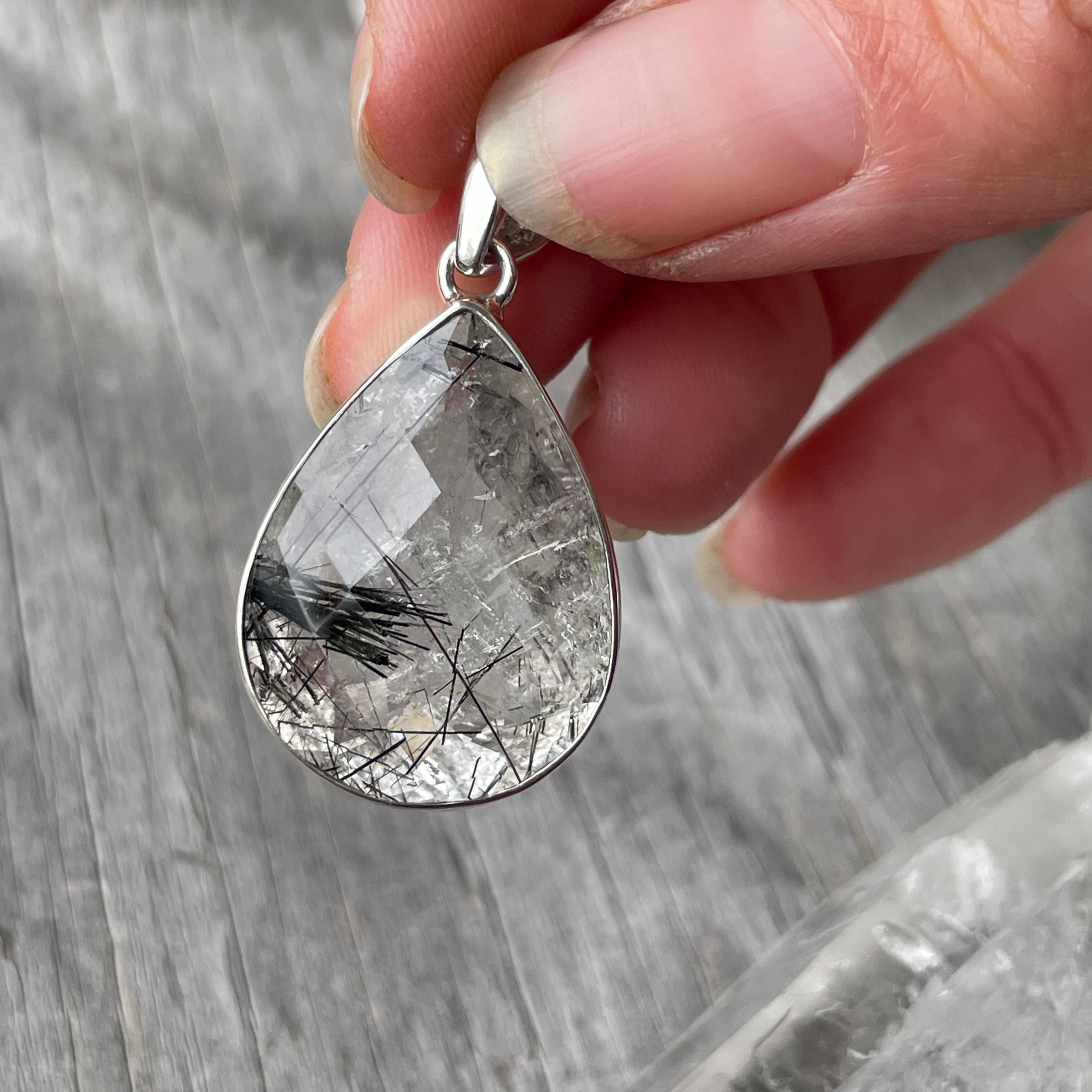 Wide teardrop fully faceted tourmaline in quartz pendant
