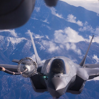 An F-35B Lightning II fighter jet refuels midflight from the perspective of the refueling aircraft..