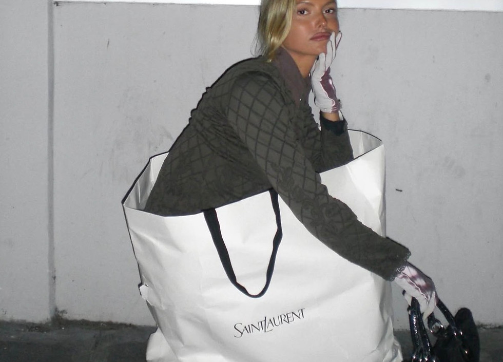 Woman sitting in a large shopping bag