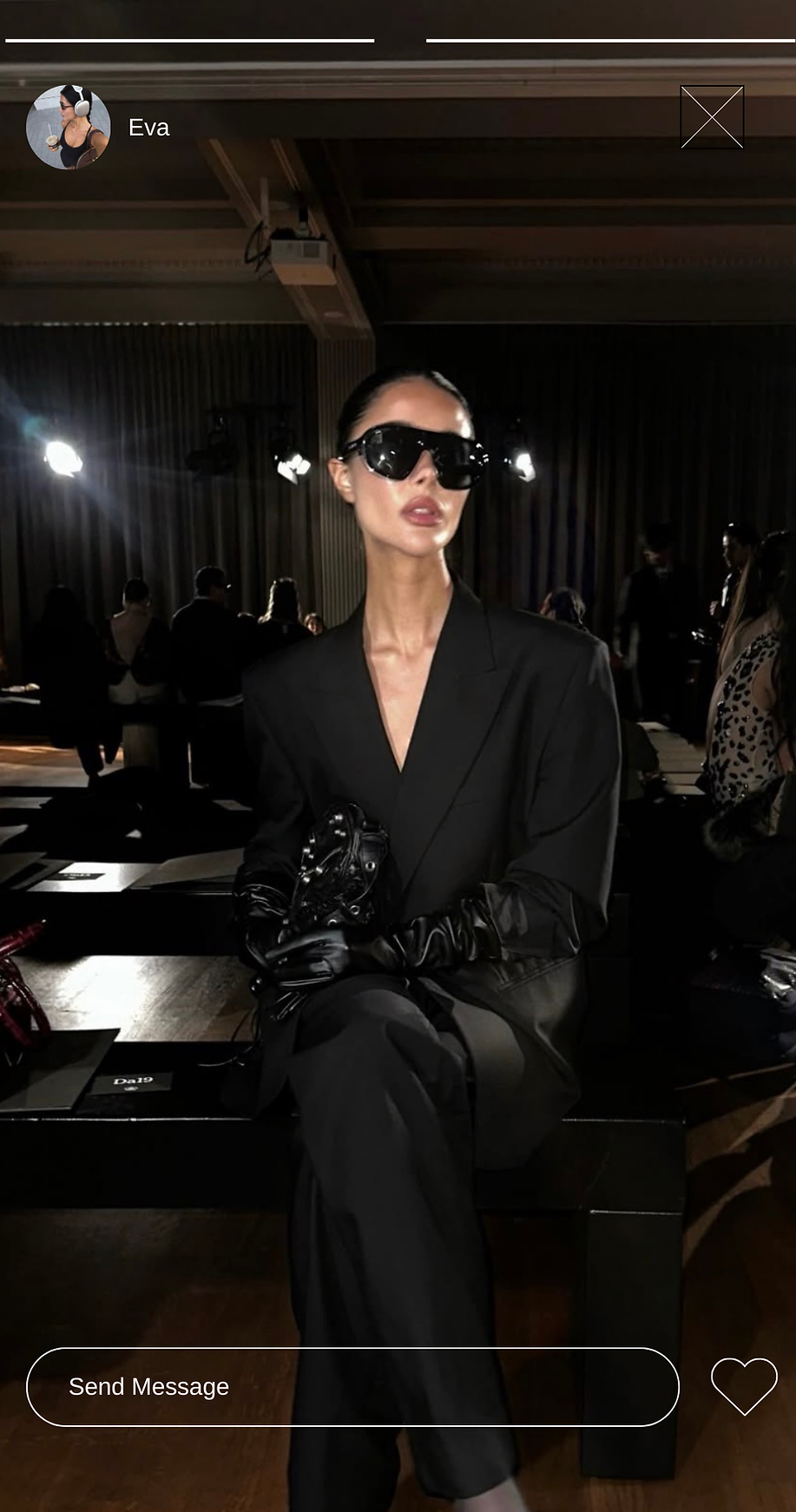 Woman in black suit and sunglasses