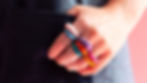 hand with lots of colourful powder-coated rings