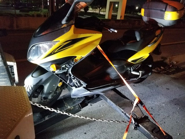 yellow motorcycle being towed