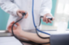 doctor taking patient's blood presssure