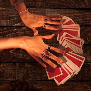 hands with bangles and rings touching red tarot cards over a wooden table How to Know Which Tarot Card Meaning Applies to Your Situation by Gem Blackthorn