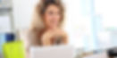 Smiling woman in front of her laptop