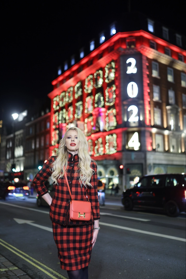 A girl poses outside the Fortnum & Mason store