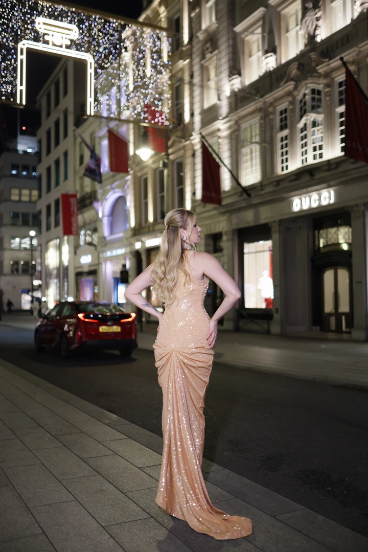 A girl poses outside the Gucci store
