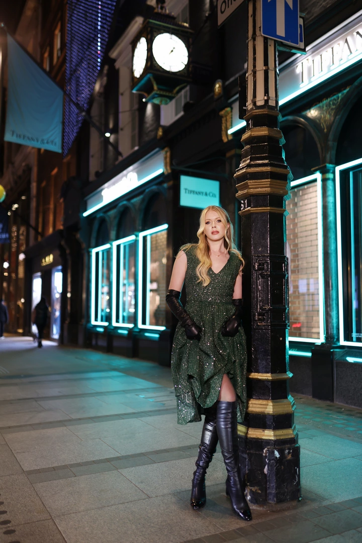 A girl poses for a photo outside a Tiffany store