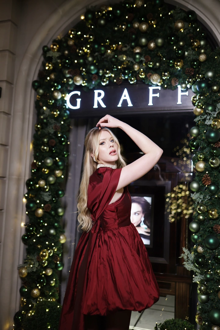 A girl poses outside the Graff store