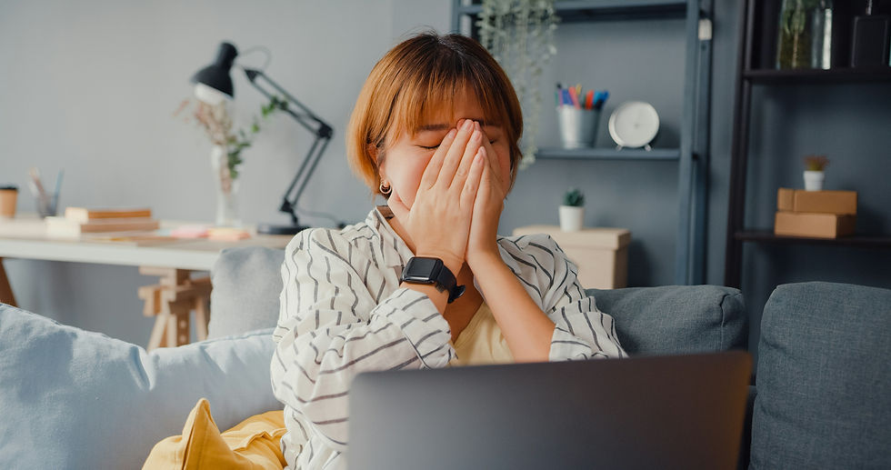 A frustrated person sitting at a computer.