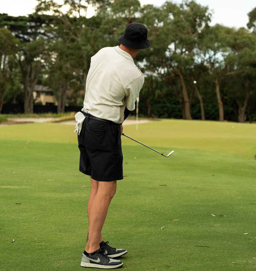 Golfer swinging club, golf coaching
