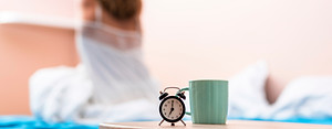 close-up-cup-clock-with-stretching-woman-background.jpg