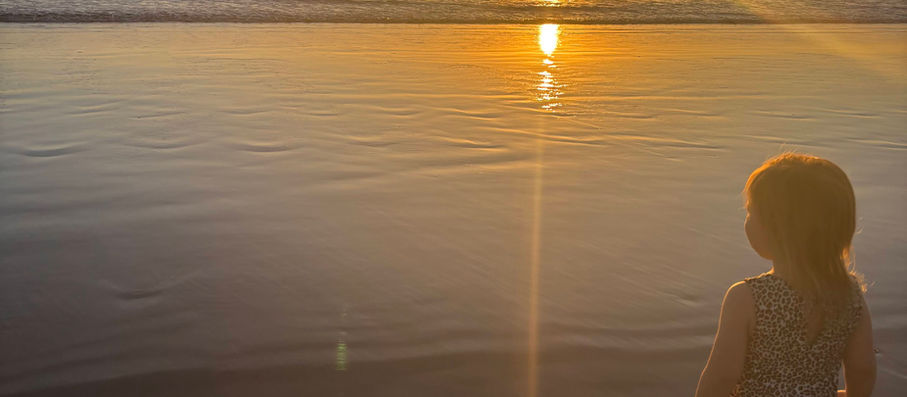 Toddler watching sunset in Taghazout