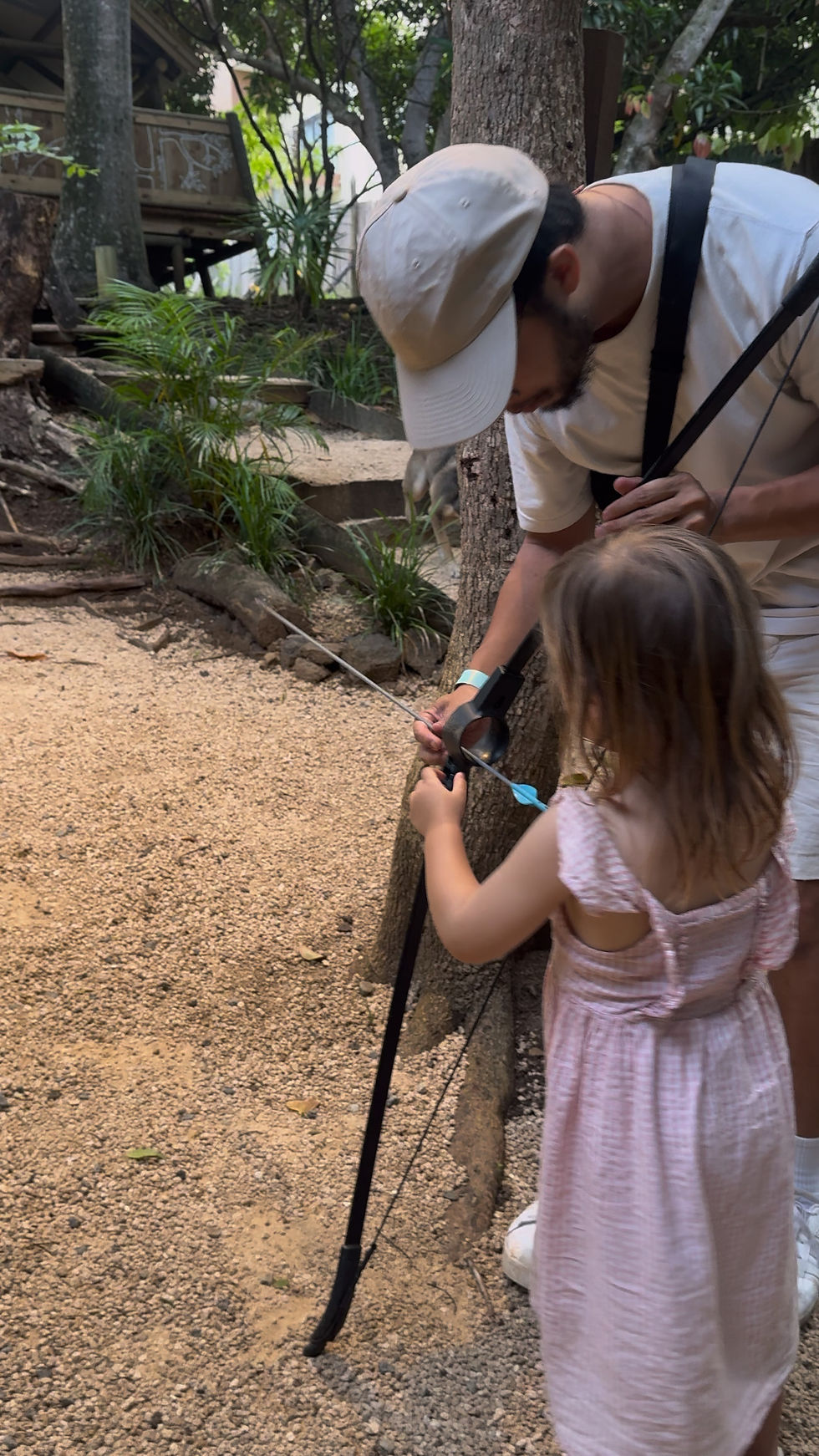 Toddler with parent doing Archery at Otentic, Mauritius