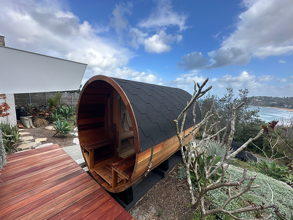 Vista Series cedar barrel sauna with rear window and front porch by Wandering Sauna