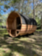 Wanderer Series 4–6 person cedar barrel sauna with porch by Wandering Sauna