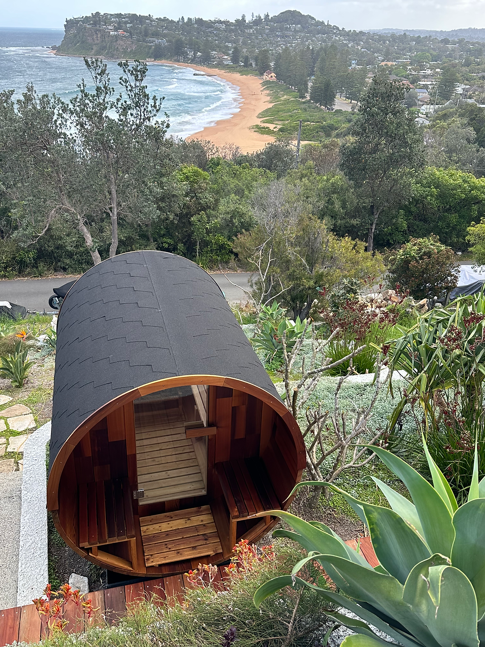 Vista Series cedar barrel sauna with rear window and front porch by Wandering Sauna