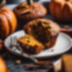 healthy pumpkin spice muffin on plate with pumpkins in background