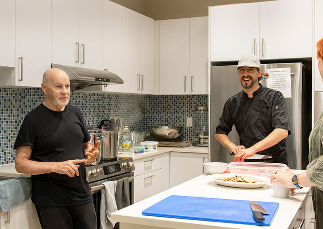 A member of the Sacred Cuisine team preparing a dish.
