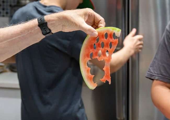 A member of the Sacred Cuisine team preparing a dish.