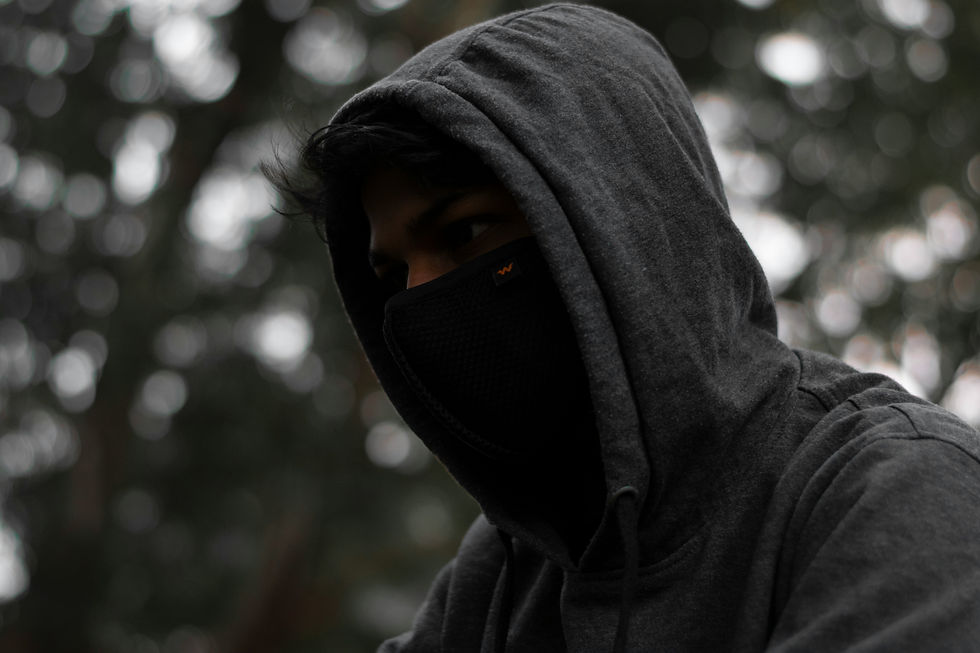 Person in a hoodie with face covered.