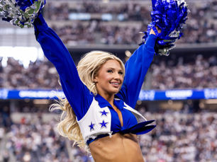A Dallas Cowboys cheerleader cheers during an NFL game
