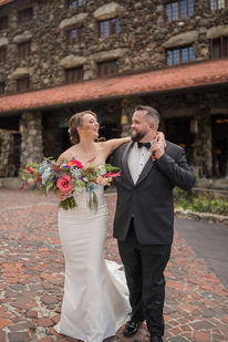 Married couple walking towards camera, laughing. They traveled to north carolina to get married at the Omni Grove Park Inn in Asheville!