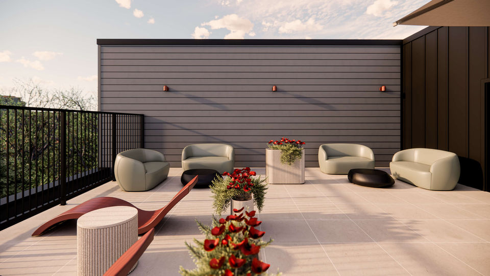 Terrasse commune sur le toit avec mobilier moderne et jardinières fleuries à Altitude 33 à Mirabel.