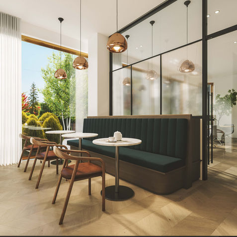 Espace lounge moderne avec banquette verte et chaises en bois.