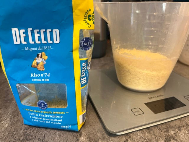 Orzo pasta, weighed out in preparation for cooking. 