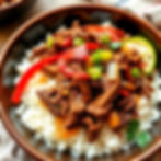 shredded ropa vieja short rib with red and green peppers and onions over white rice.jpg