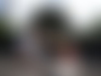 Kona Mike's surf instructor showing students how to pop-up on the shore.