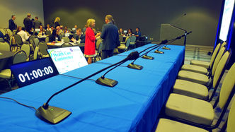 Empty panelist table with pro audiovisual setup of 