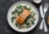 Pan fried salmon on a bed of wilted spin