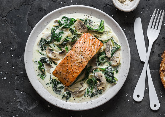 Pan fried salmon on a bed of wilted spin
