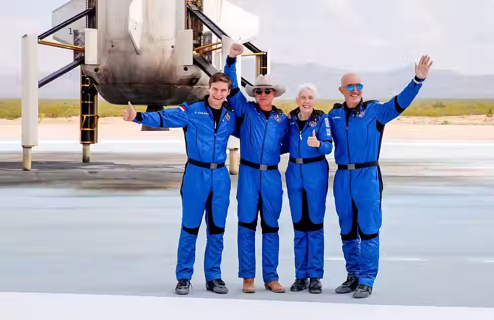 Jeff Bezos, second from left, with crew mates, from left, Oliver Damen, 18, Wally Funk, 82, and Mark Bezos at the landing pad after they flew on Blue Origin's inaugural flight to the edge of space, in the nearby town of Van Horn, Texas, on July 20, 2021.Joe Skipper / Reuters