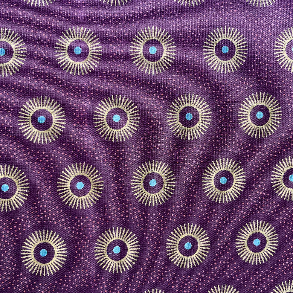 Close up of brown Shweshwe fabric with sun circle design