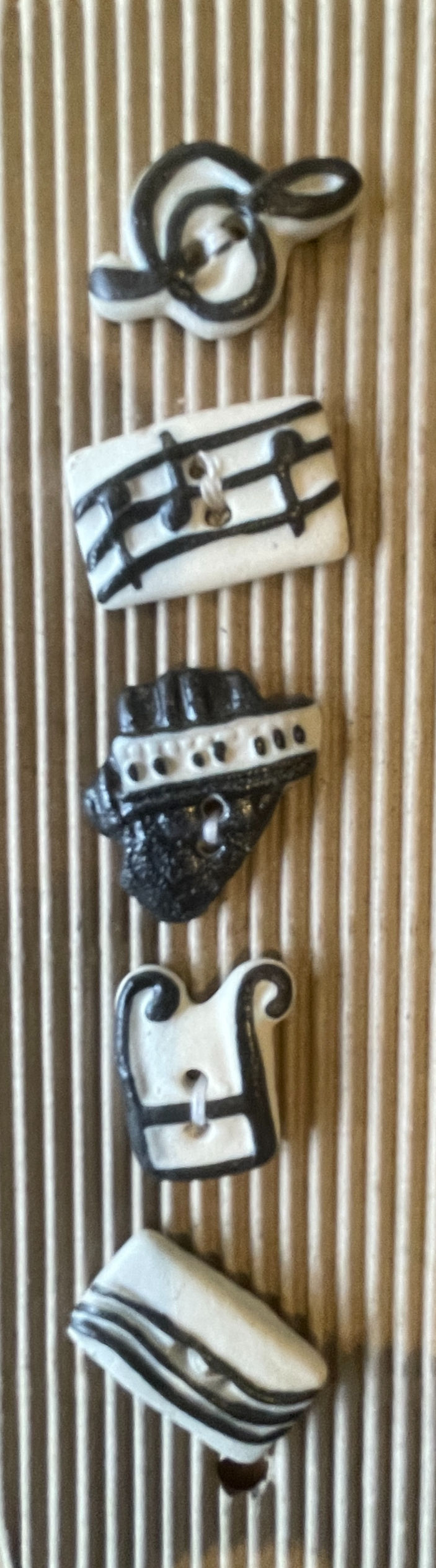 handmade ceramic music buttons featuring treble clef drum and guitar