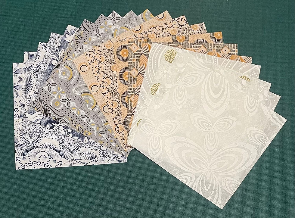 Dassie Squares Light Pack with 20 colourful 5 inch Shweshwe fabric squares arranged in a fan layout