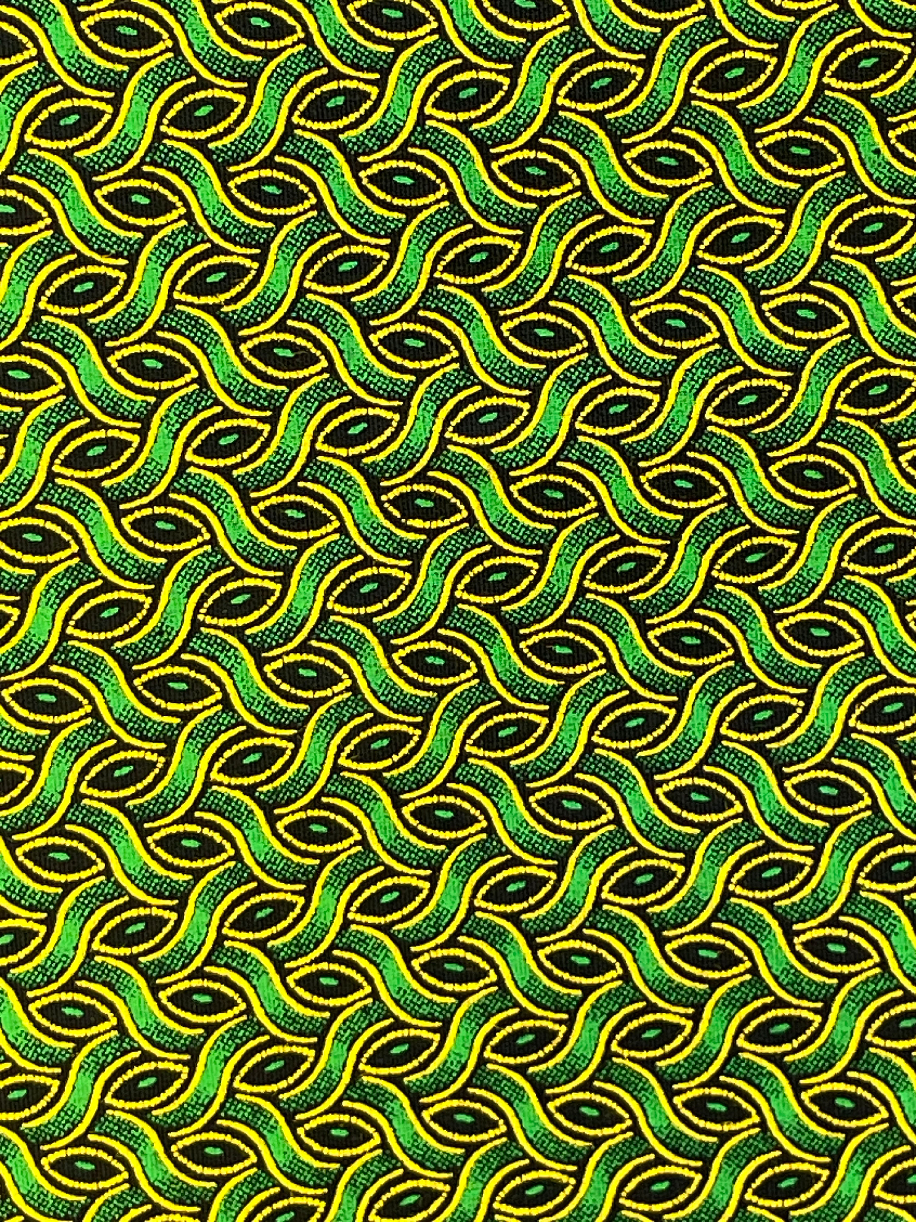 Close-up of Green Weave Shweshwe fabric showing green and yellow interlocking shapes on black