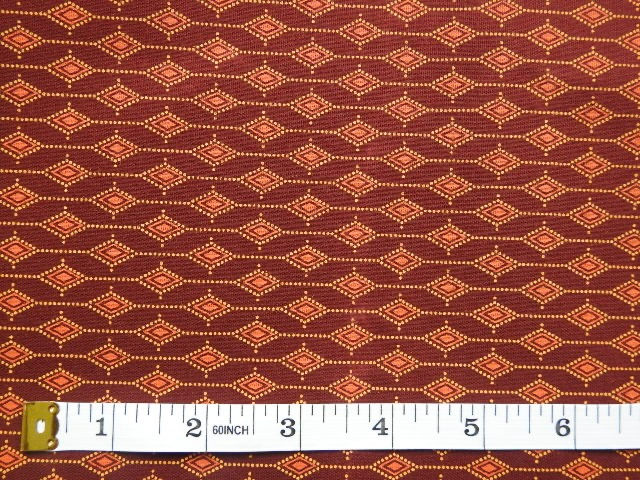 Thumbnail: Brown Shweshwe fabric – diamond chains with tape measure 10-inch scale, Da Gama Three Cats