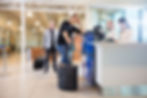 Frustrated and delayed traveller trying to get help at an airline desk