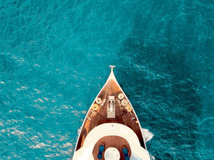 A yacht enters dreamy blue waters