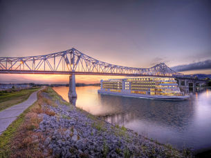 A Viking cruise ship passes beneath a bridge on the Mississippi River.