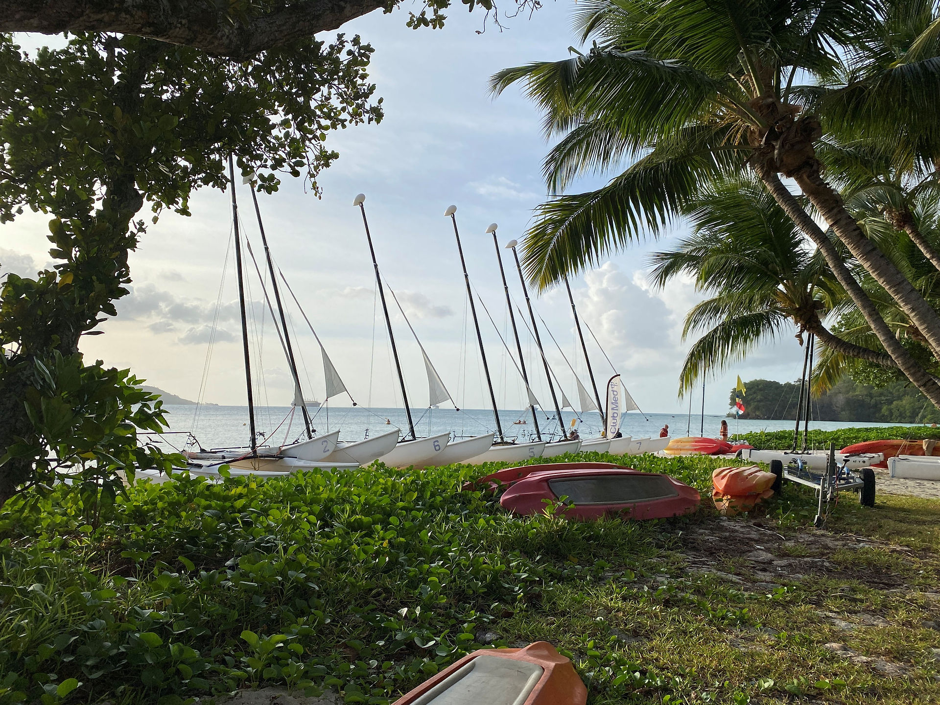 The boats you can take out to sail lined up on the beach at Club Med Seychelles