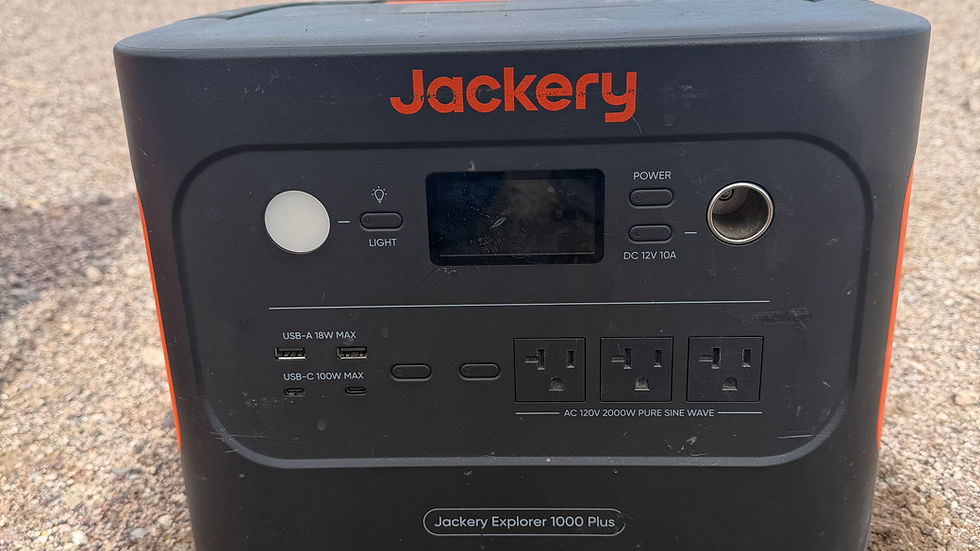 Jackery Explorer 1000 plus power station sitting in camp.