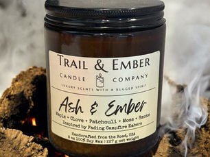 Photo of Ash & Ember candle by Trail & Ember with a smouldering fire in the background