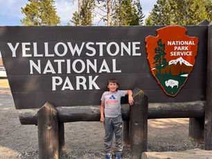 Daxton in front of the Yellowstone National Park Sign
