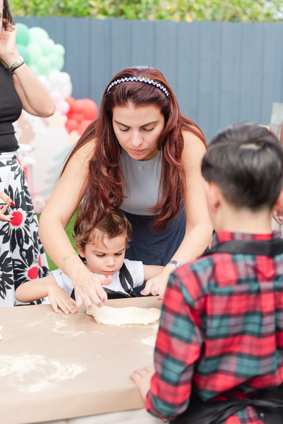 Mom & son making pizza at a party